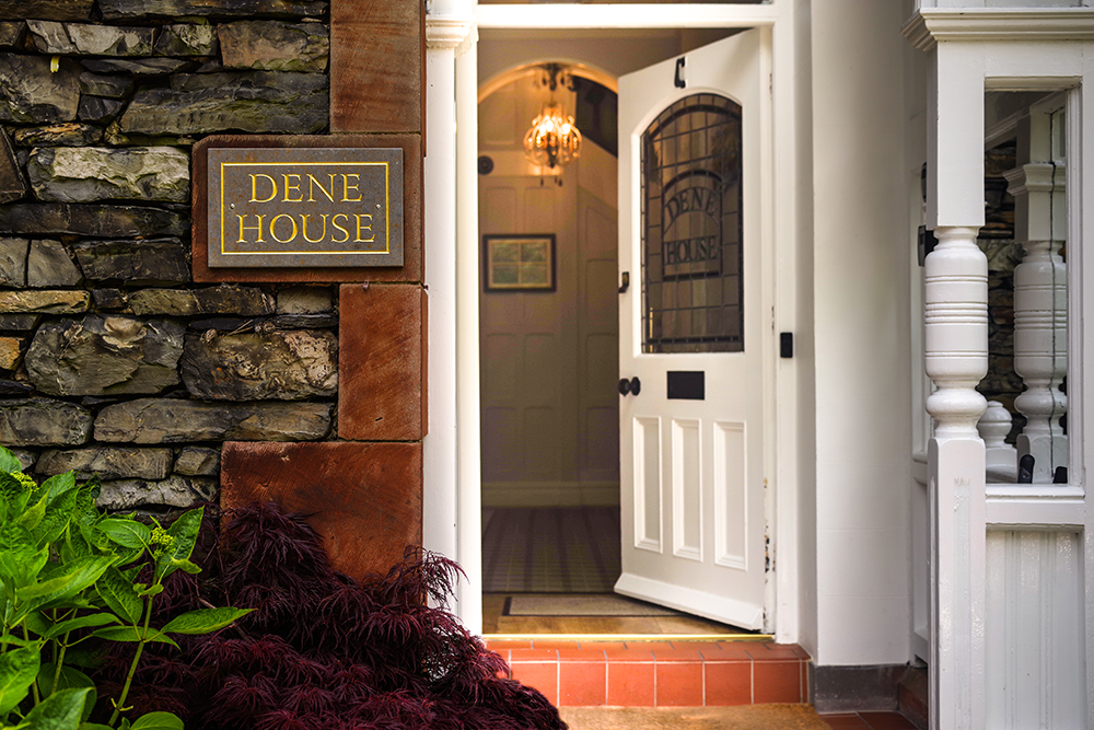 Front entrance with Dene House stone sign and white door