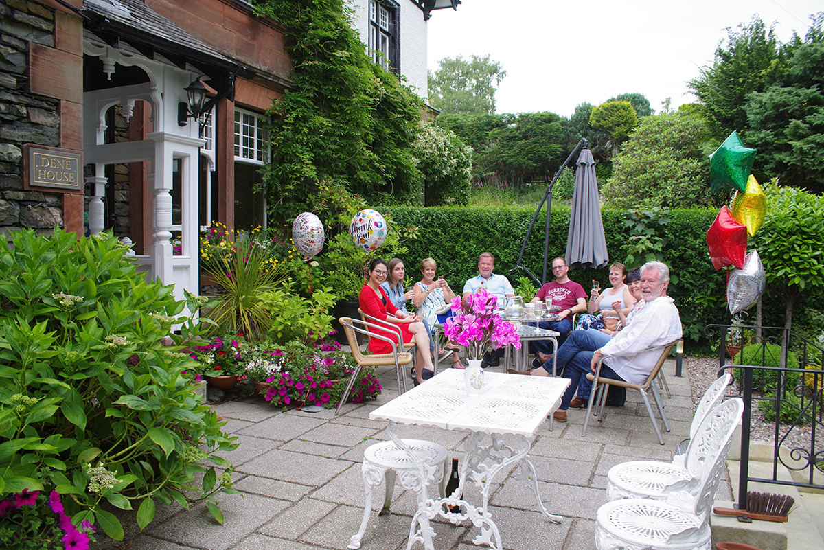 Guests having breakfast on the garden terrace